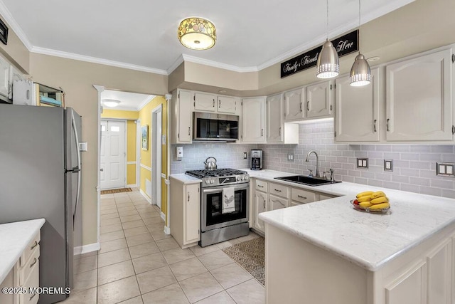 8 Yellowstone Ln, Howell, NJ 07731 - kitchen with stainless steel appliances, crown molding, backsplash, light tile patterned floors, and a peninsula