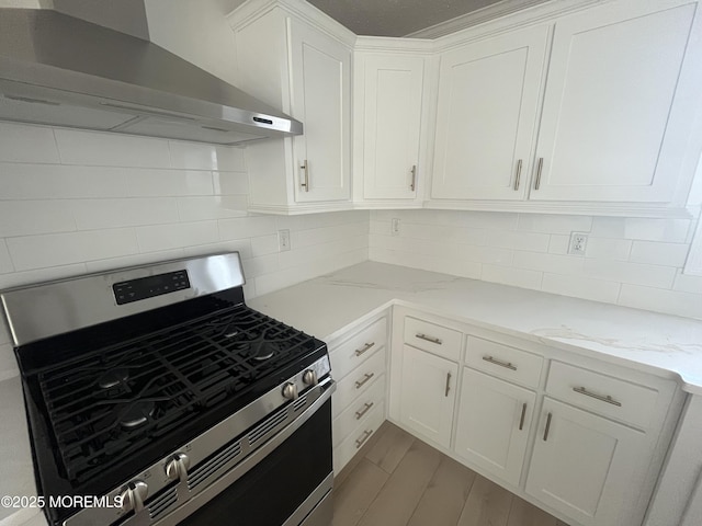 191 US Highway 9 Unit 14, Englishtown, NJ 07726 - kitchen featuring wall chimney range hood, stainless steel range with gas cooktop, white cabinets, and backsplash