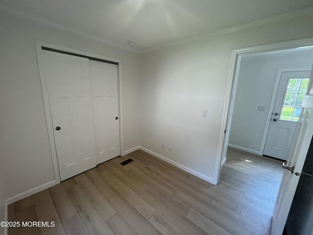 191 US Highway 9 Unit 14, Englishtown, NJ 07726 - unfurnished bedroom with light wood-style floors, a closet, and ornamental molding