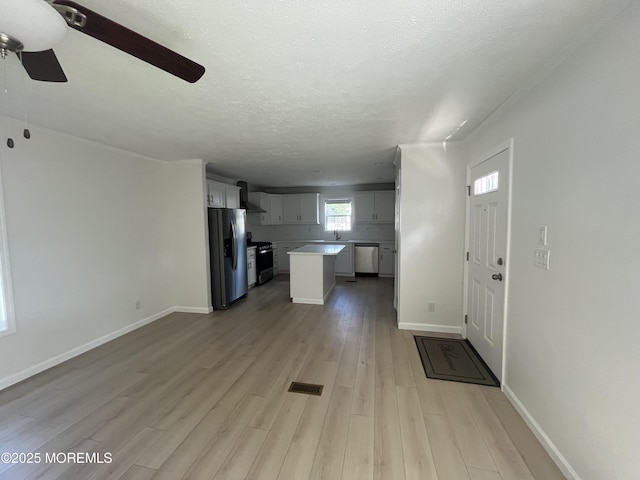 191 US Highway 9 Unit 14, Englishtown, NJ 07726 - unfurnished living room with a ceiling fan, light wood finished floors, and a textured ceiling