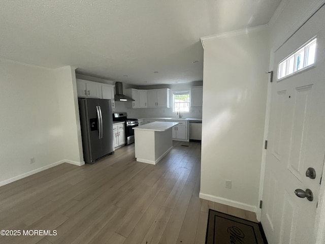 191 US Highway 9 Unit 14, Englishtown, NJ 07726 - kitchen with stainless steel appliances, wall chimney exhaust hood, white cabinets, light wood-style floors, and a kitchen island