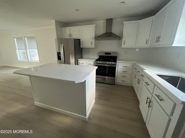 191 US Highway 9 Unit 14, Englishtown, NJ 07726 - kitchen with stainless steel appliances, wall chimney range hood, light wood-type flooring, backsplash, and white cabinetry