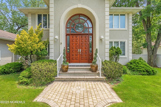 7 Wallace Ave, Oakhurst, NJ 07755 - doorway to property featuring stucco siding and a yard