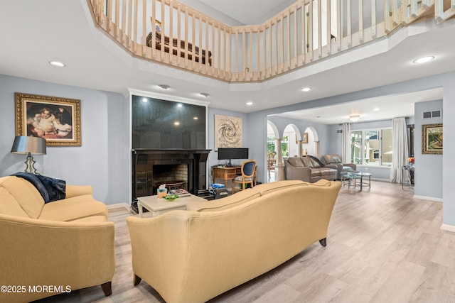 7 Wallace Ave, Oakhurst, NJ 07755 - living room with a large fireplace, recessed lighting, light wood-style flooring, and a towering ceiling