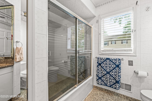 7 Wallace Ave, Oakhurst, NJ 07755 - full bathroom featuring a tile shower, vanity, and tile walls