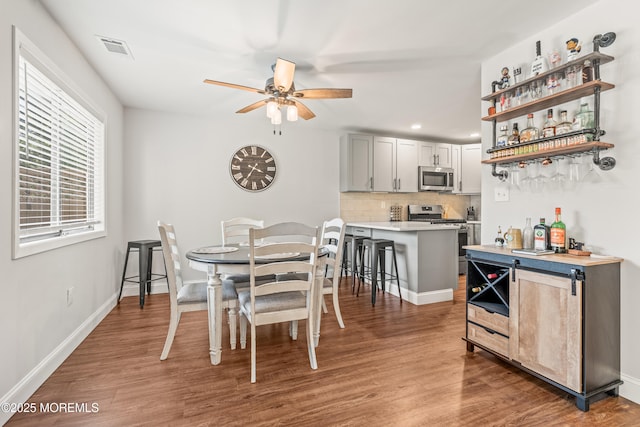 50 Lenape Trl, Tinton Falls, NJ 07724 - dining area with ceiling fan, wood finished floors, a bar, and recessed lighting