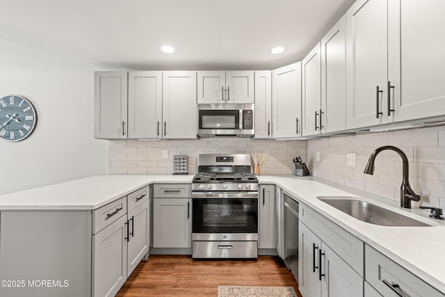 50 Lenape Trl, Tinton Falls, NJ 07724 - kitchen with stainless steel appliances, a peninsula, light countertops, recessed lighting, and light wood finished floors
