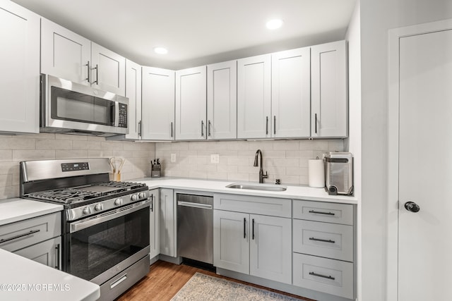 50 Lenape Trl, Tinton Falls, NJ 07724 - kitchen with appliances with stainless steel finishes, light countertops, light wood finished floors, recessed lighting, and backsplash