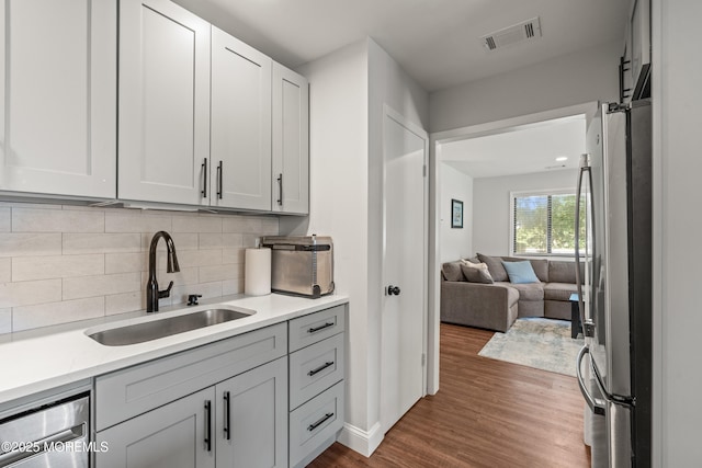 50 Lenape Trl, Tinton Falls, NJ 07724 - kitchen featuring stainless steel appliances, dark wood finished floors, tasteful backsplash, open floor plan, and white cabinets