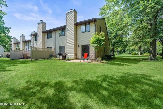 50 Lenape Trl, Tinton Falls, NJ 07724 - rear view of property with a chimney and a patio