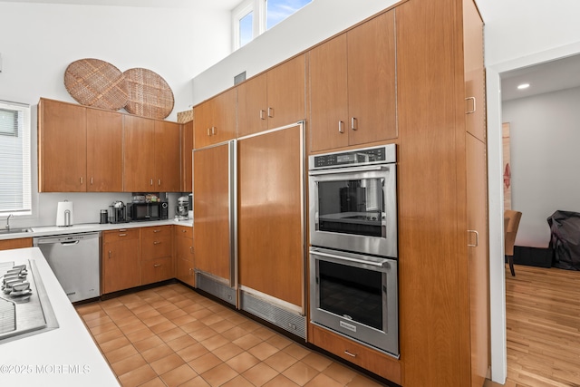 460 Runyan Ave, Deal, NJ 07723 - kitchen with appliances with stainless steel finishes, light countertops, a towering ceiling, brown cabinets, and recessed lighting