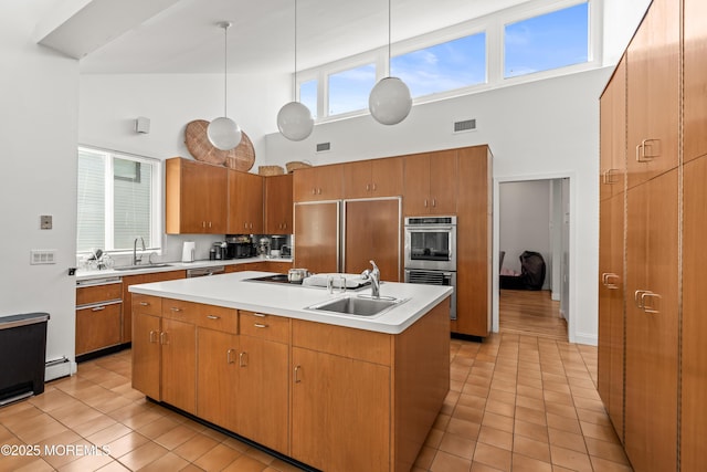460 Runyan Ave, Deal, NJ 07723 - kitchen with a towering ceiling, appliances with stainless steel finishes, light tile patterned floors, an island with sink, and light countertops