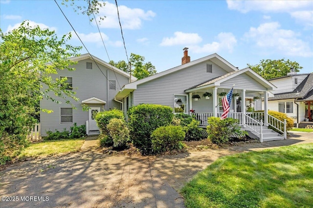 3 Sutphin Ave, Matawan, NJ 07747 - view of front facade with a porch, a chimney, and a front yard