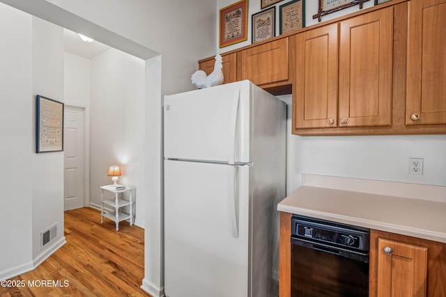 4 Ocean Ave Unit 5, Ocean Grove, NJ 07756 - kitchen featuring freestanding refrigerator, brown cabinetry, light wood-type flooring, and light countertops