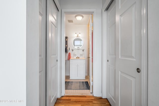 4 Ocean Ave Unit 5, Ocean Grove, NJ 07756 - corridor with light wood-style floors and a sink