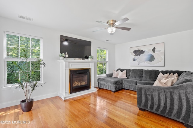 9 Nutmeg Ct, Tinton Falls, NJ 07753 - living room featuring light wood finished floors, ceiling fan, and a glass covered fireplace