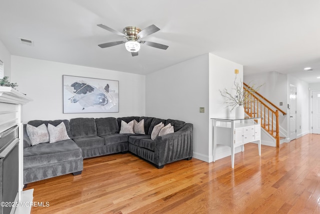 9 Nutmeg Ct, Tinton Falls, NJ 07753 - living area with stairway, light wood finished floors, a ceiling fan, recessed lighting, and a fireplace