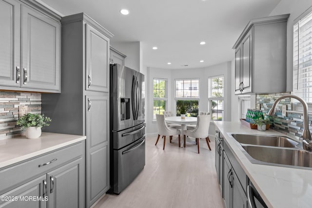 9 Nutmeg Ct, Tinton Falls, NJ 07753 - kitchen featuring stainless steel refrigerator with ice dispenser, gray cabinets, tasteful backsplash, light wood-style floors, and recessed lighting