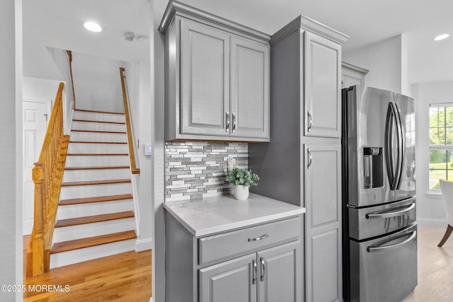 9 Nutmeg Ct, Tinton Falls, NJ 07753 - kitchen featuring stainless steel refrigerator with ice dispenser, gray cabinets, decorative backsplash, light countertops, and recessed lighting