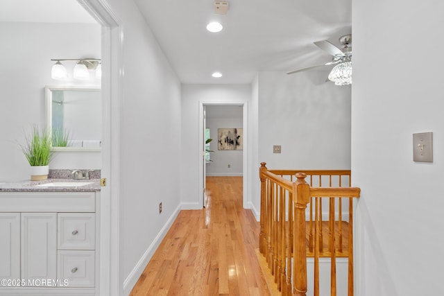 9 Nutmeg Ct, Tinton Falls, NJ 07753 - hallway with an upstairs landing, light wood finished floors, and recessed lighting