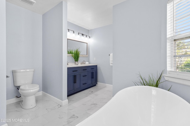 9 Nutmeg Ct, Tinton Falls, NJ 07753 - bathroom with marble finish floors, a freestanding bath, and vanity