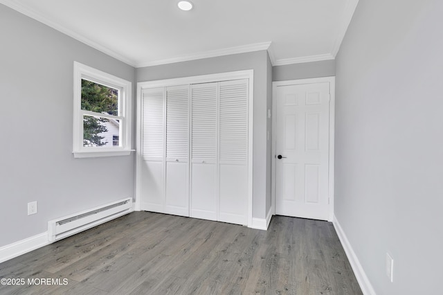 163 Courtshire Dr, Brick, NJ 08723 - unfurnished bedroom featuring baseboard heating, crown molding, wood finished floors, and a closet