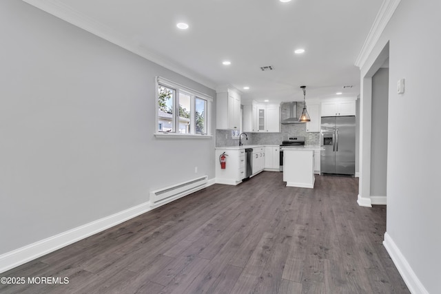 163 Courtshire Dr, Brick, NJ 08723 - kitchen with appliances with stainless steel finishes, a baseboard heating unit, wall chimney range hood, crown molding, and white cabinetry