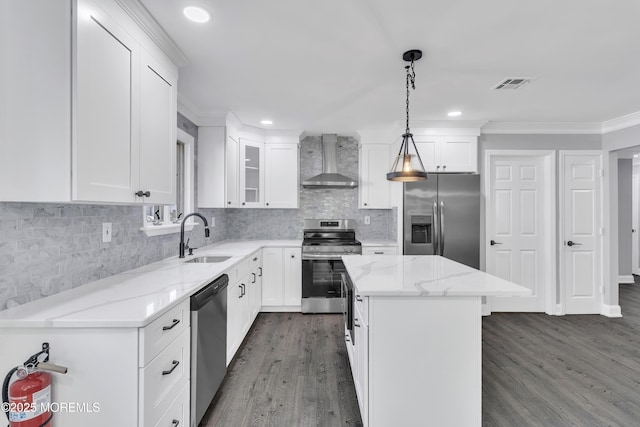 163 Courtshire Dr, Brick, NJ 08723 - kitchen with wall chimney exhaust hood, appliances with stainless steel finishes, dark wood finished floors, a kitchen island, and light stone countertops