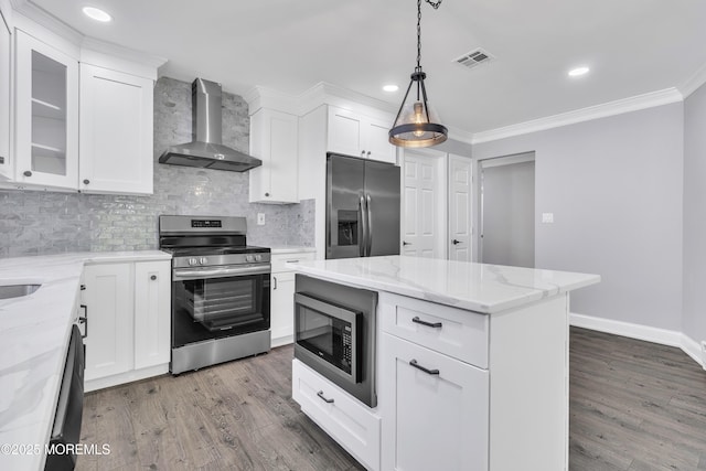 163 Courtshire Dr, Brick, NJ 08723 - kitchen featuring appliances with stainless steel finishes, wall chimney range hood, wood finished floors, tasteful backsplash, and recessed lighting