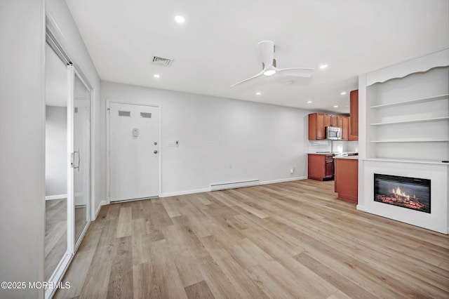 43 Cambridge Ct Unit K, Lakewood, NJ 08701 - unfurnished living room featuring a baseboard radiator, a ceiling fan, light wood-type flooring, a glass covered fireplace, and recessed lighting