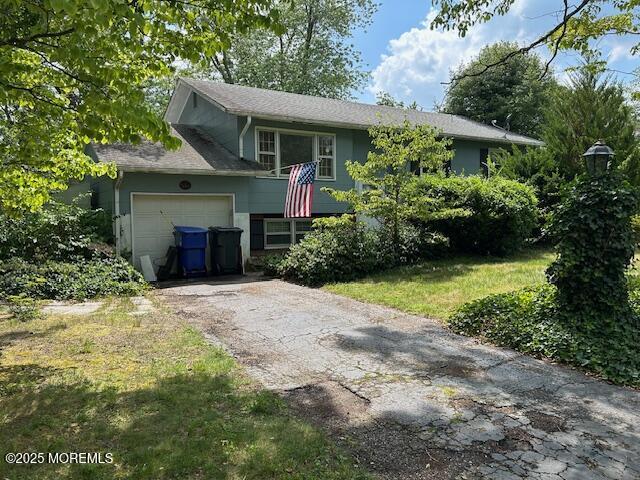1599 Woodcrest Dr, Toms River, NJ 08753 - split foyer home with asphalt driveway and a garage