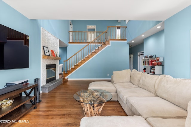 2262 Allenwood Rd, Allenwood, NJ 08720 - living area with wood finished floors, a stone fireplace, stairs, and recessed lighting