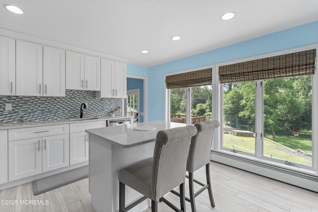 2262 Allenwood Rd, Allenwood, NJ 08720 - kitchen featuring baseboard heating, a kitchen breakfast bar, backsplash, white cabinetry, and recessed lighting