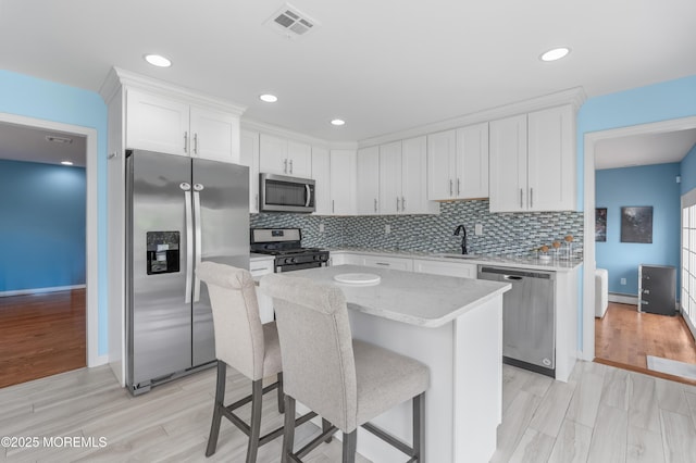 2262 Allenwood Rd, Allenwood, NJ 08720 - kitchen with stainless steel appliances, white cabinetry, a kitchen island, backsplash, and recessed lighting