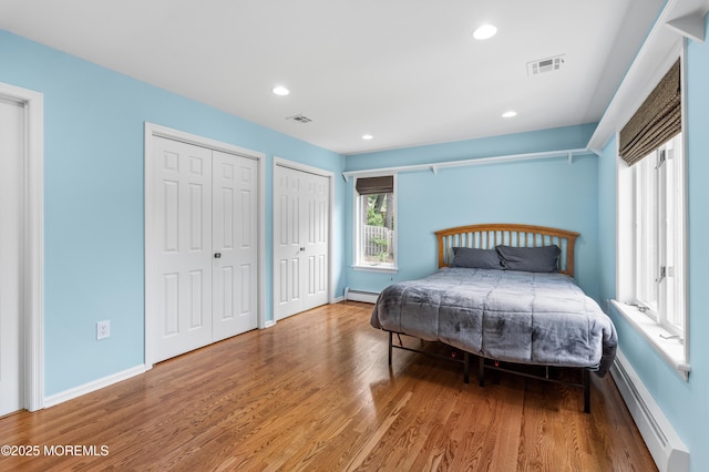 2262 Allenwood Rd, Allenwood, NJ 08720 - bedroom with a baseboard heating unit, wood finished floors, two closets, and recessed lighting