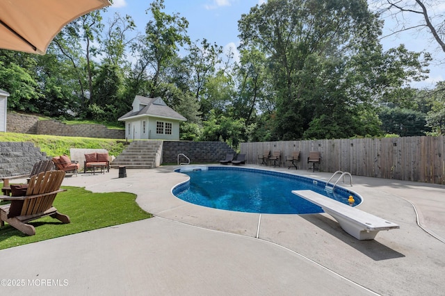 2262 Allenwood Rd, Allenwood, NJ 08720 - view of swimming pool with a patio area, a diving board, an outdoor structure, and view of wooded area