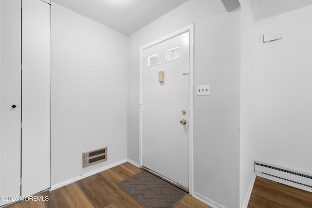 117 Clay Cir, Brick, NJ 08724 - entrance foyer featuring a baseboard heating unit and wood finished floors