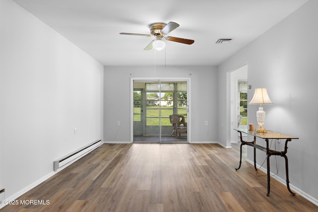 117 Clay Cir, Brick, NJ 08724 - unfurnished room featuring a baseboard heating unit, wood finished floors, and a ceiling fan