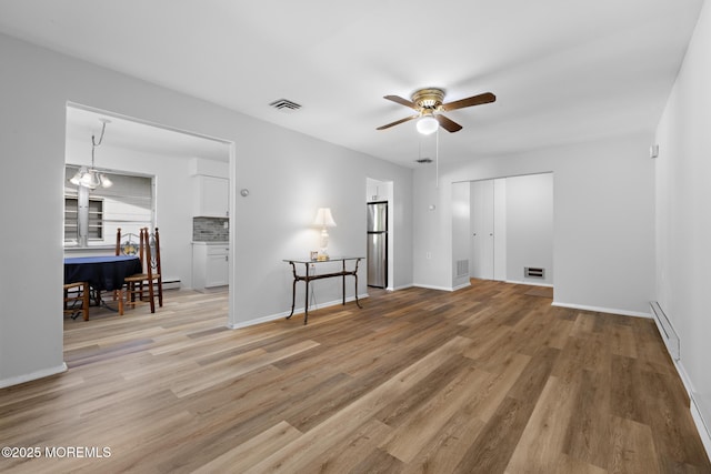 117 Clay Cir, Brick, NJ 08724 - living area featuring baseboard heating, a ceiling fan, and light wood finished floors