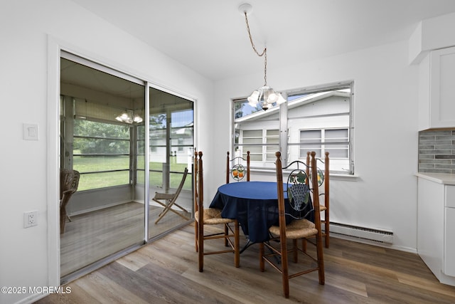 117 Clay Cir, Brick, NJ 08724 - dining room featuring baseboard heating, wood finished floors, and a chandelier