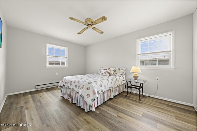 117 Clay Cir, Brick, NJ 08724 - bedroom with baseboard heating, wood finished floors, and ceiling fan