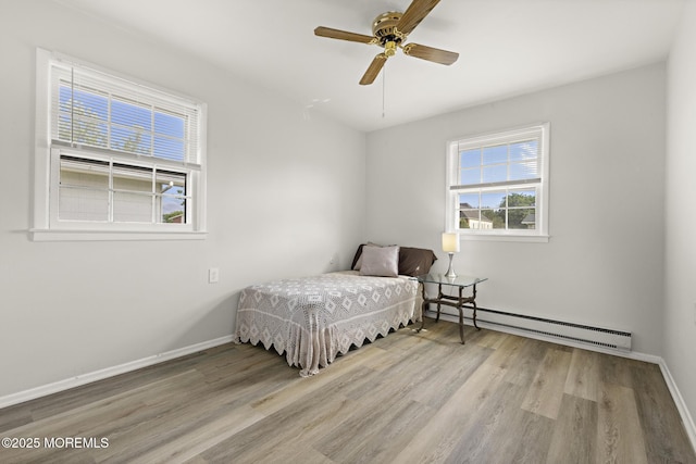 117 Clay Cir, Brick, NJ 08724 - bedroom with baseboard heating, wood finished floors, multiple windows, and a ceiling fan