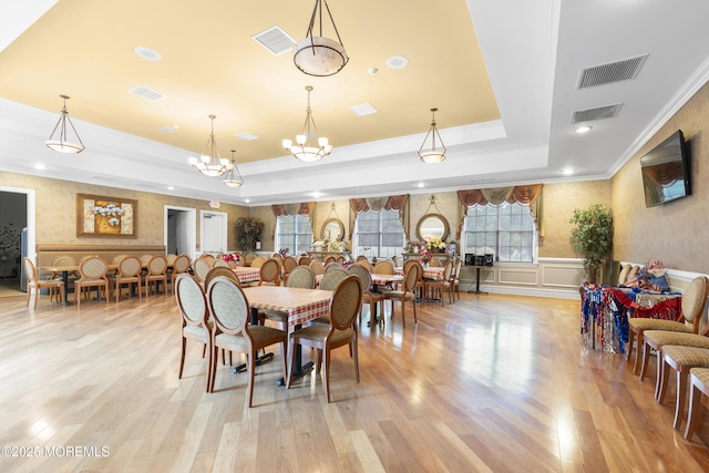 428 Sophee Ln, Lakewood, NJ 08701 - dining room featuring ornamental molding, a tray ceiling, wainscoting, light wood-type flooring, and a chandelier