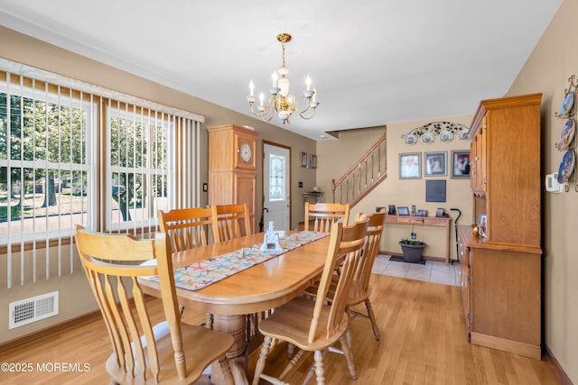 2010 Pine Meadow Ave, Toms River, NJ 08753 - dining area with stairs, a chandelier, and light wood-type flooring
