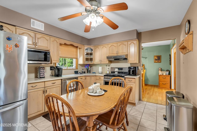 2010 Pine Meadow Ave, Toms River, NJ 08753 - kitchen with appliances with stainless steel finishes, under cabinet range hood, light brown cabinetry, light countertops, and light tile patterned flooring