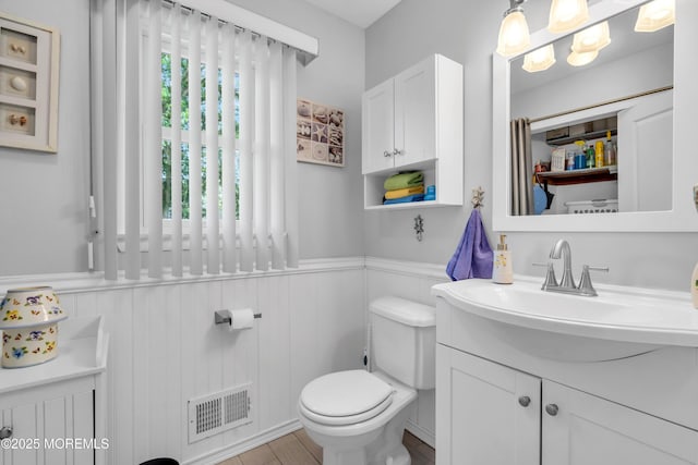 2010 Pine Meadow Ave, Toms River, NJ 08753 - bathroom featuring vanity, a wainscoted wall, and wood finished floors