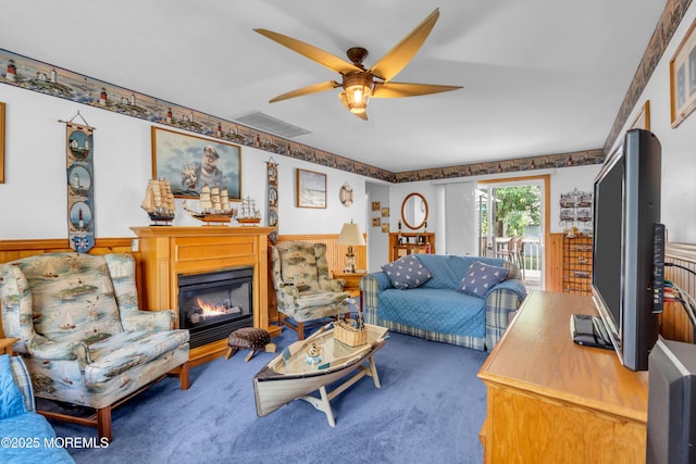 2010 Pine Meadow Ave, Toms River, NJ 08753 - carpeted living area featuring a ceiling fan, a glass covered fireplace, and a wainscoted wall