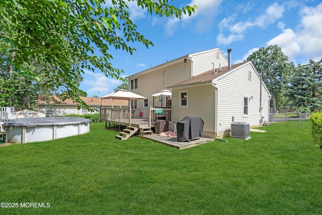 2010 Pine Meadow Ave, Toms River, NJ 08753 - rear view of property featuring a wooden deck, a covered pool, and a shingled roof
