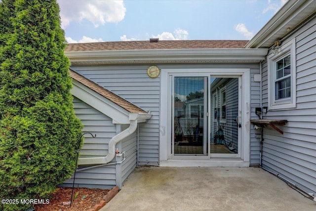 128 Korn Market Unit E, Freehold, NJ 07728 - doorway to property with a patio area and roof with shingles