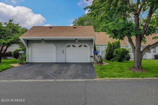 128 Korn Market Unit E, Freehold, NJ 07728 - view of front facade featuring driveway, a front yard, a shingled roof, and an attached garage